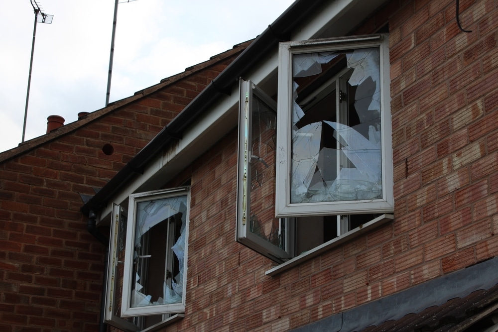 Property damaged with two broken glass windows.
