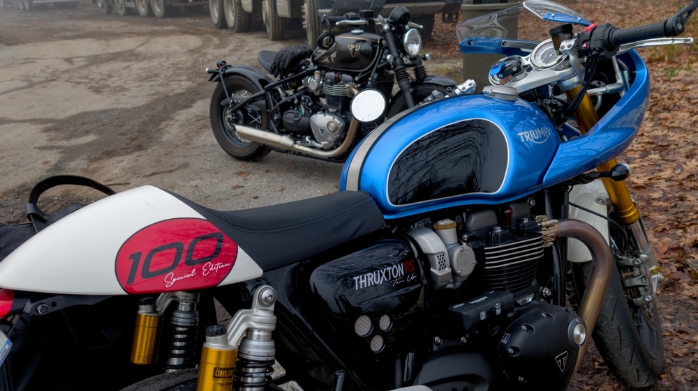 Blue Thruxton motorcycle parked with a black motorcycle behind it.